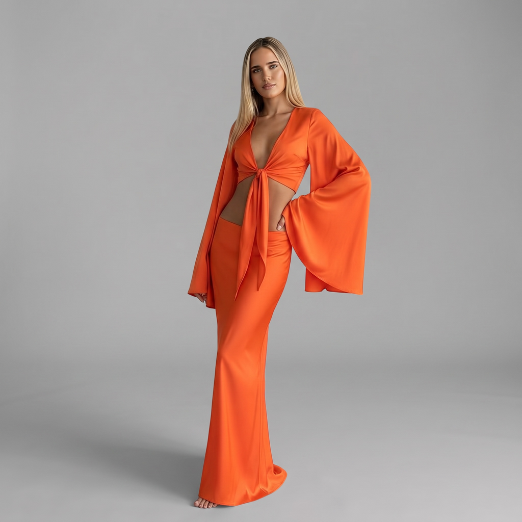 girlzhood Lava Muse Maxi Set in Sunset-Orange mit tiefem V-Ausschnitt, Bindung und weiten Statement-Ärmeln an Model